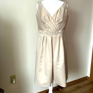 A line dress satin dress. Beaded waistband. Pleated bust. Slimmer arm openings.